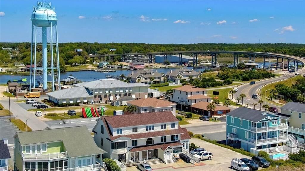 A coastal town with a prominent water tower, a bridge, and a marina.