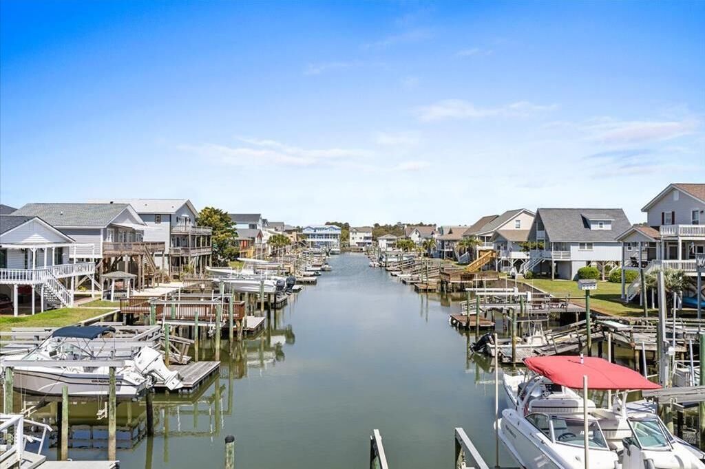 A marina with docked boats and waterfront houses.