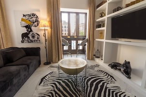 Deluxe Apartment, Balcony, City View | Living area | TV