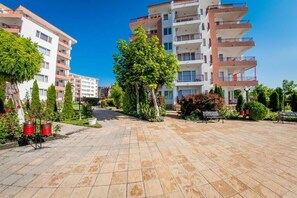 Stunning residential complex with balconies and lush greenery.