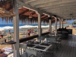 Enjoy a meal under the shade of our outdoor dining area, overlooking the ocean.