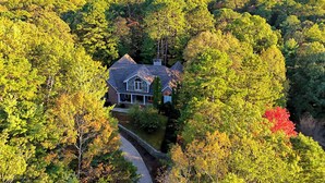 A house surrounded by dense forest with a clear view of the surrounding hills. - Gold Leaf Chalet (Helen)