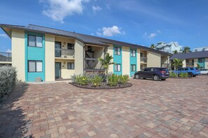 A multi-story building with a flat roof, numbered windows, and a paved driveway. - Vacation At Bac Bay! Fun In The Sun! 2B/2B Condo Walk To Beach! (Fort Myers Beach)