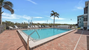 A swimming pool with lounge chairs and palm trees. - Vacation At Bac Bay! Fun In The Sun! 2B/2B Condo Walk To Beach! (Fort Myers Beach)