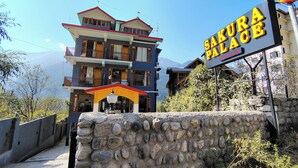 A multi-story building with a sign reading "SAKURA PALACE." - Hotel Sakura Palace (Manali)