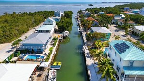 A coastal residential area with houses, a marina, and a swimming pool.