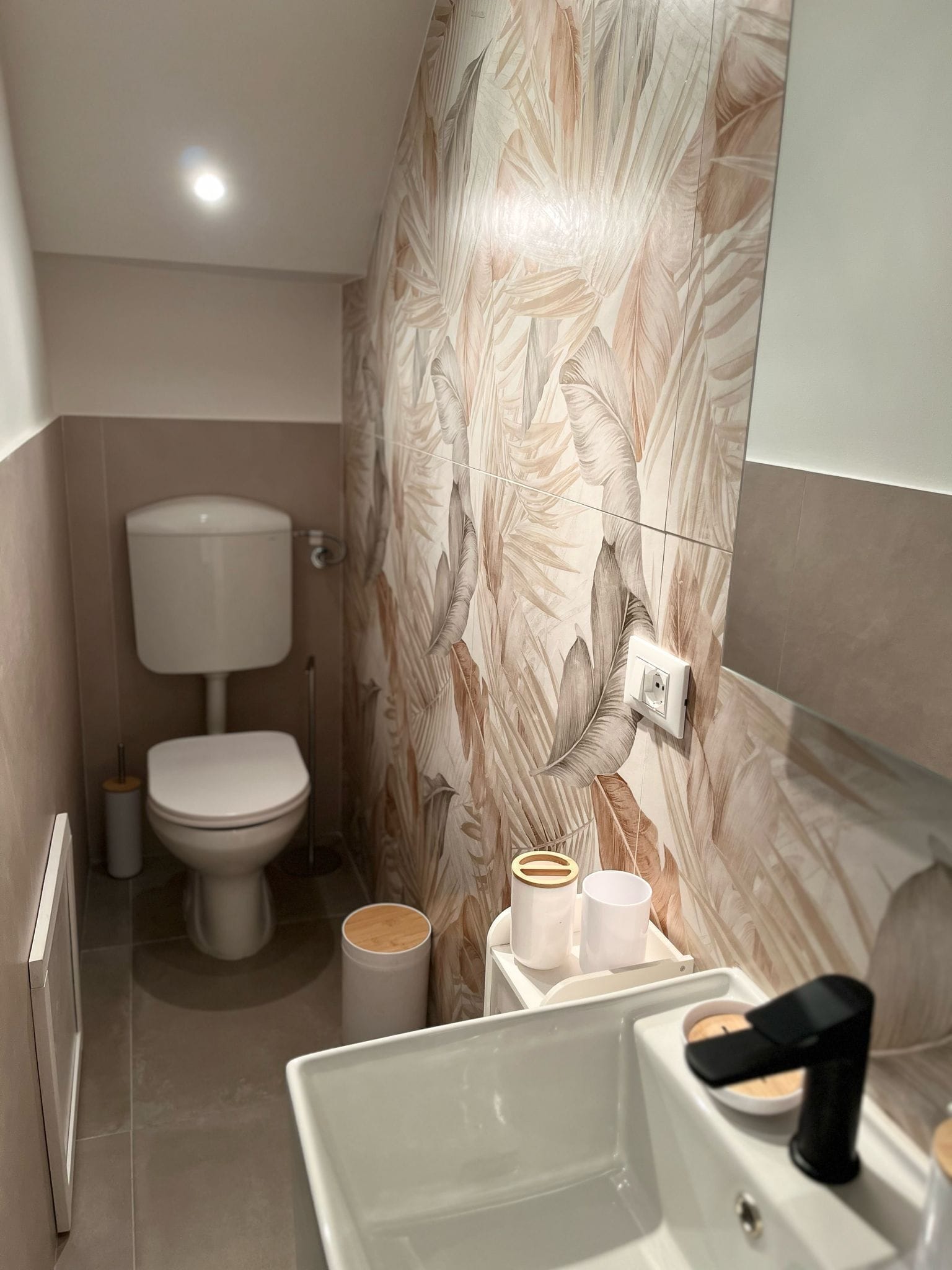 A modern bathroom with a toilet, bidet, and a bathtub.