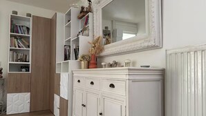 A room with a white cabinet, a bookshelf, and a mirror. - Quiet House (Amiens)