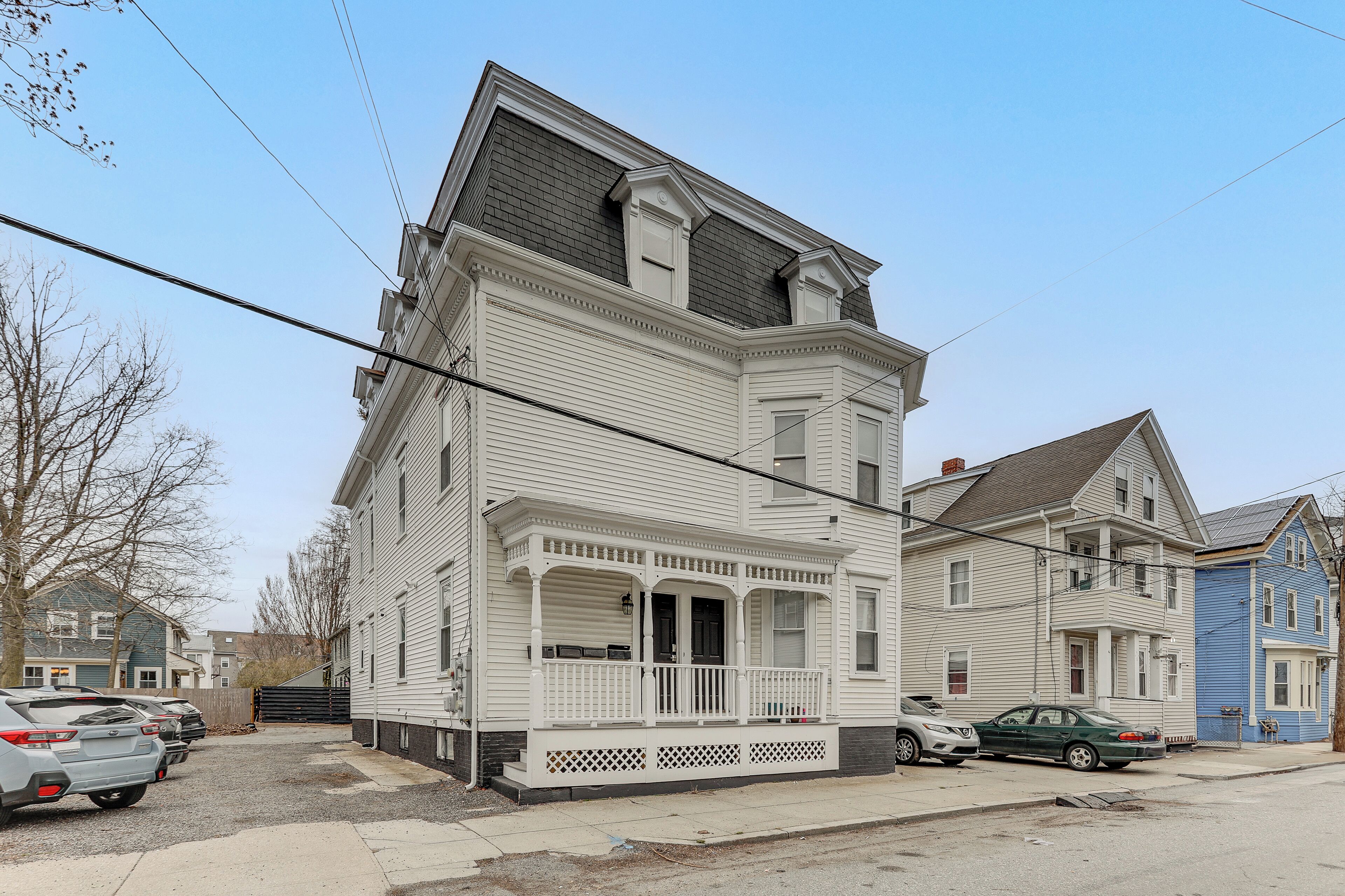 A two-story house with a porch, a garage, and a driveway.