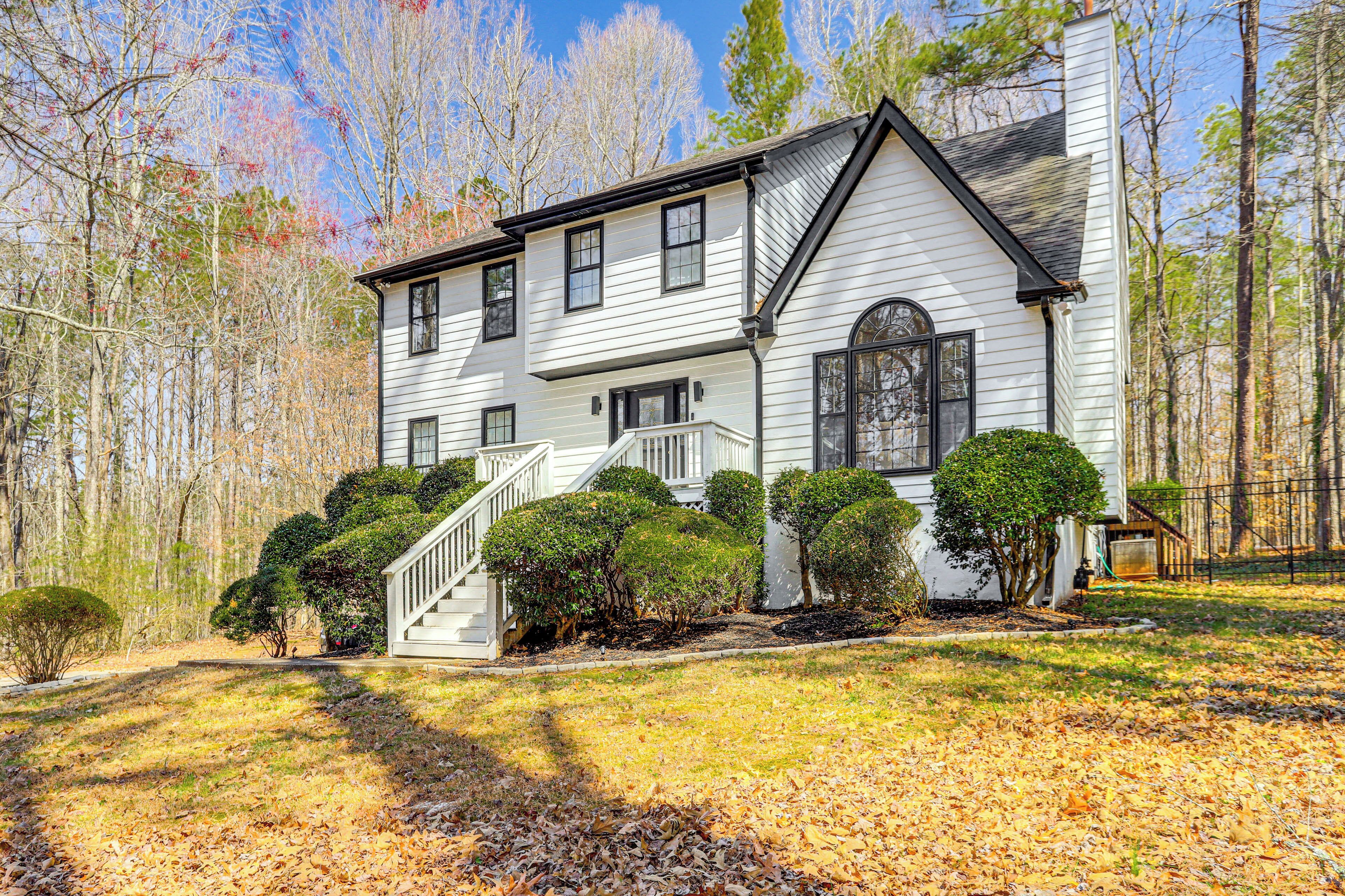 A two-story house with a front porch, a staircase, and a well-maintained lawn.