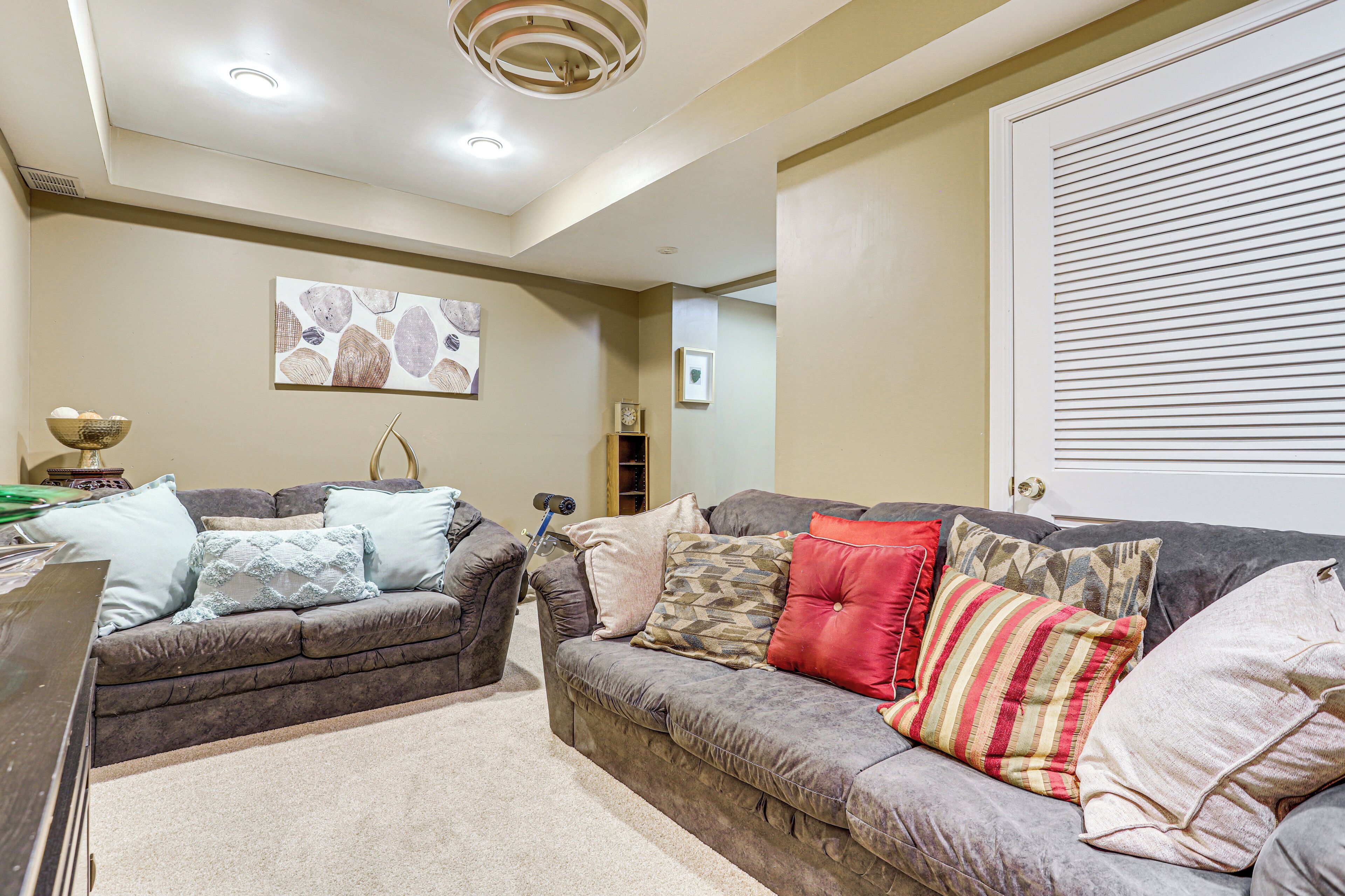 A living room with two couches, a coffee table, and a bookshelf.