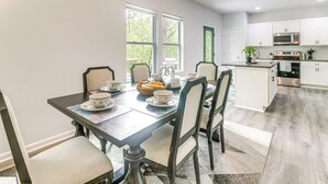 A modern kitchen with white cabinets, a built-in oven, and a microwave. - Stay & Play in Charlotte: Family Home w/ Deck (Charlotte)