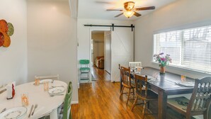 A dining area with a wooden table, chairs, and a ceiling fan. - Farmhouse w/ Horse Corral Near Wind River Arena (Rigby)