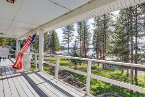A covered deck with a view of a lake and forest. - Steps to Pine Hollow Reservoir: Home w/ Fire Pit! (Tygh Valley)