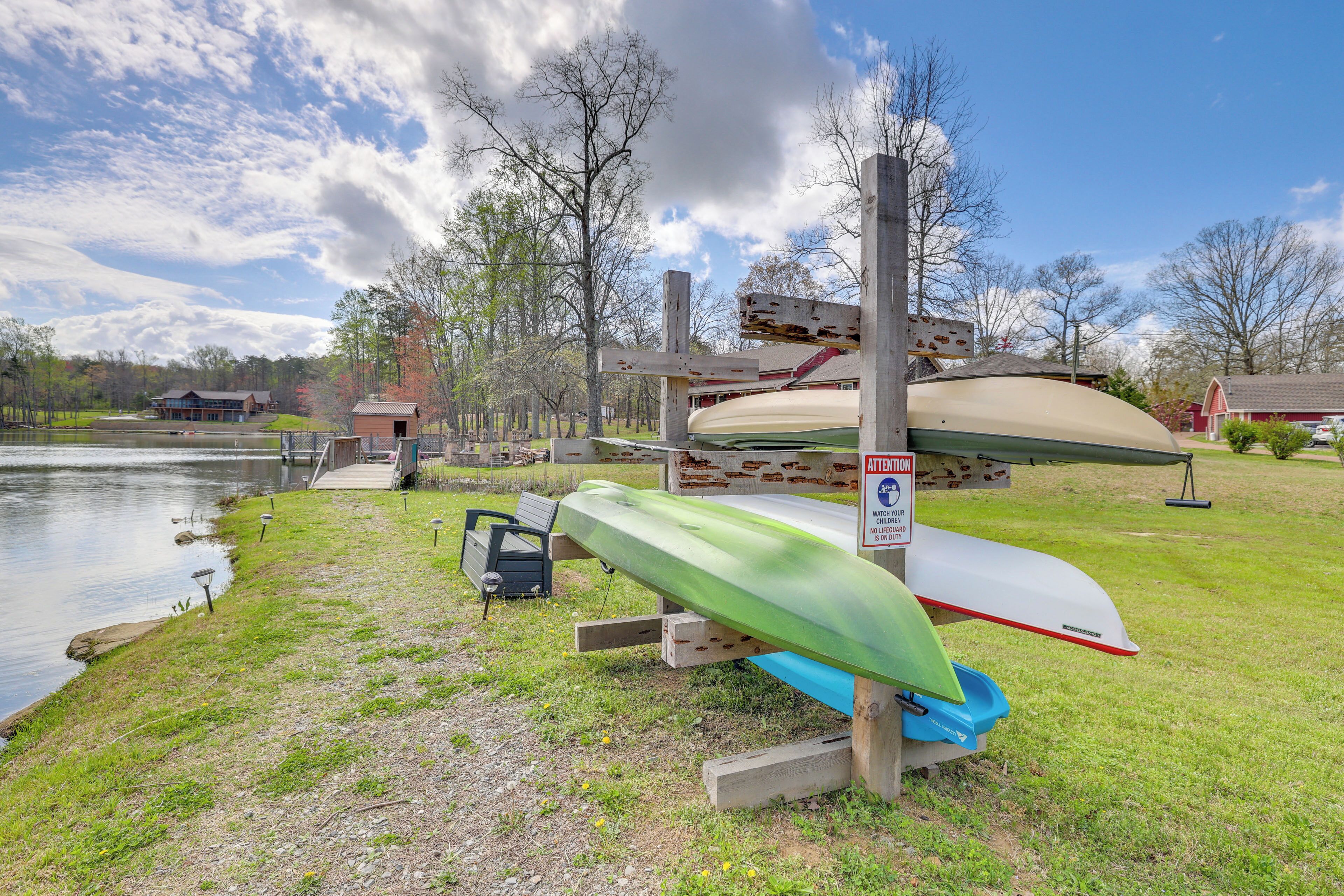 A lakeside area with canoes and a picnic table.