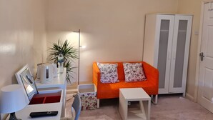 A compact living space with a sofa, a cabinet, a table, and a lamp. - KELVIN HOUSE (Ferryhill)