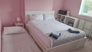 A bedroom with two beds, a desk, a kettle, and a radiator. - KELVIN HOUSE (Ferryhill)