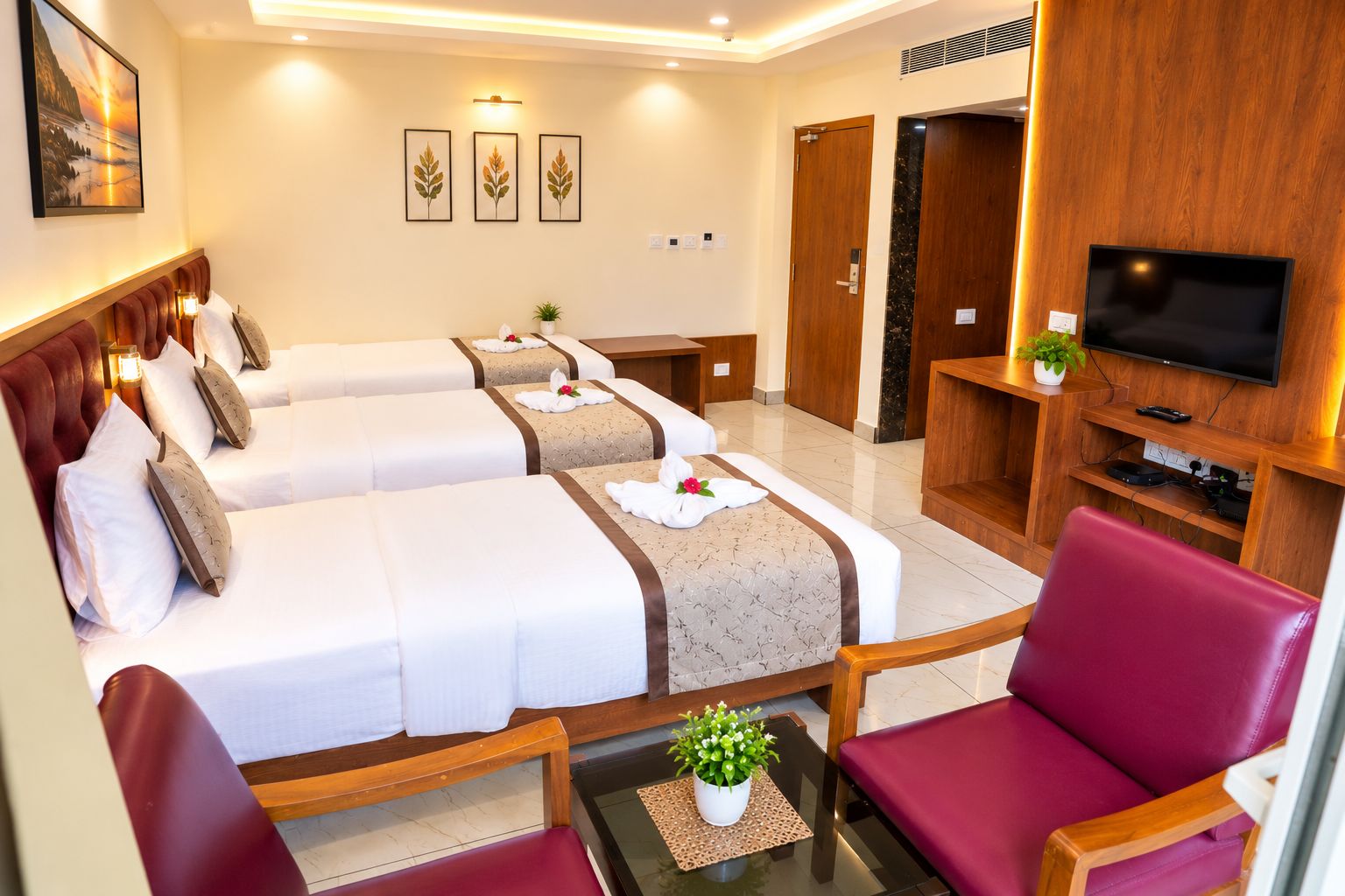 A hotel room with two beds, a TV, a seating area, and a wooden wall.