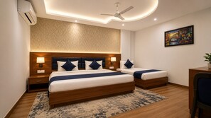 A hotel room with a large bed, two bedside tables, a ceiling fan, and a painting on the wall. - Hotel Paradise International by JMD Group (New Delhi)
