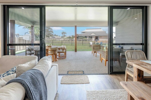 Relax in this inviting living room with a sliding glass door leading to a patio area.