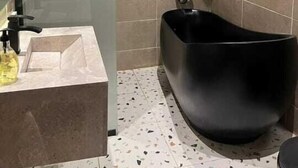 A modern bathroom with a freestanding bathtub, a glass shower enclosure, and a marble sink. - welcome apartment (Jeddah)
