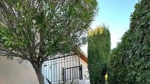 A staircase leading up to a building with a beige exterior and a black metal gate. - French Riviera Villa (Biot)