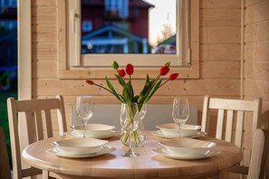 Enjoy meals with family and friends in this dining area, featuring a round table and comfortable seating for four.