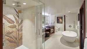 A modern bathroom with a glass-enclosed shower, a freestanding bathtub, and a mosaic wall. - HGVC Hokulani Waikiki Luxury, 1 BR Suites, Rooftop Pool/Spa, Close to Ft Derussy (Honolulu)