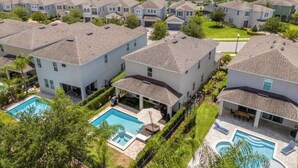 A residential area with multiple houses, each with a swimming pool and a well-maintained lawn. - Last Minute Disney! Private Pool, Hot Tub, Game Room & Themed Bedrooms. Book Now! #20220 (Orlando)