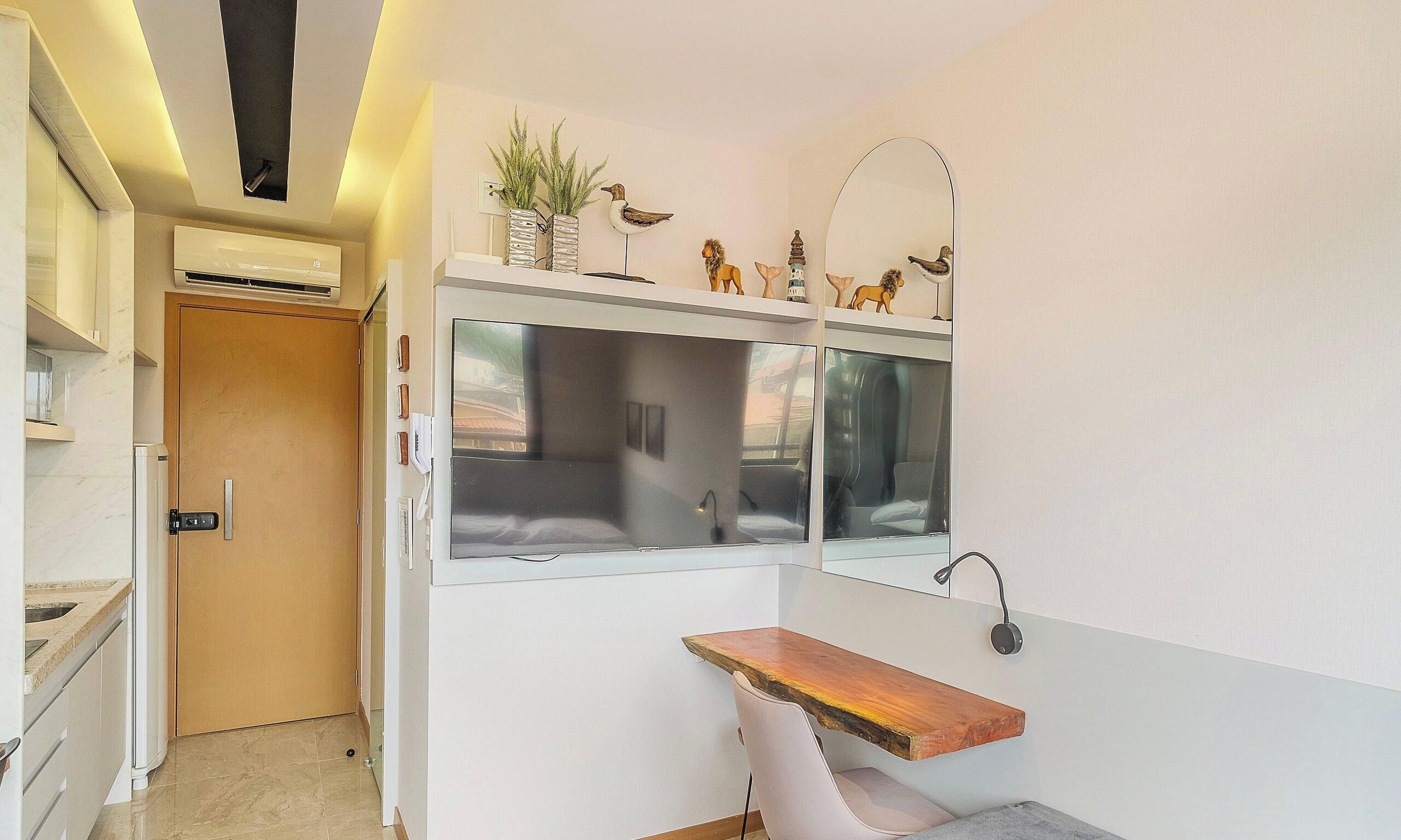 A modern bathroom with a vanity, a mirror, and a window.