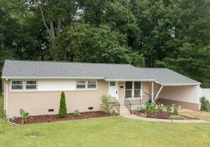 Stroll up to the charming entrance, flanked by two windows, and step into a serene suburban haven.