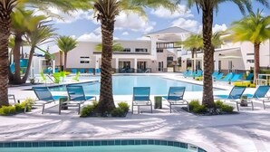 A pool area with lounge chairs and palm trees. - Last Minute Disney! Private Pool, Hot Tub, Game Room & Themed Bedrooms. Book Now! #113319 (Orlando)