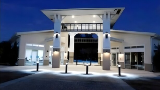A modern building with a large entrance, multiple columns, and a covered walkway. - Last Minute Disney! Private Pool, Hot Tub, Game Room & Themed Bedrooms. Book Now! #113319 (Orlando)