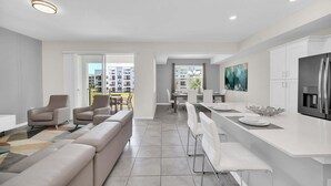 A modern apartment with a living area, dining space, and kitchen.