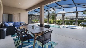 An outdoor patio with a pool, seating area, and a view of the surrounding landscape. - Last Minute Disney Getaway! Villa with Private Pool & Hot Tub. Book Now! #116909 (Orlando)