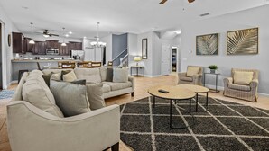 A spacious living area with a sofa, armchairs, a coffee table, and a ceiling fan. - Disney! Private Pool, Hot Tub, Game Room & Themed Bedrooms. Book Now! #CG3504 (Orlando)