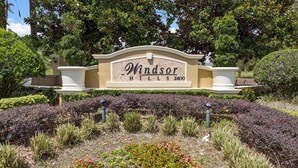 A landscaped sign with the text "Windsor Hills 2600" surrounded by various plants and shrubs. - Last Minute Disney Getaway! Private Pool & Themed Bedrooms. Book Now! #66159 (Orlando)