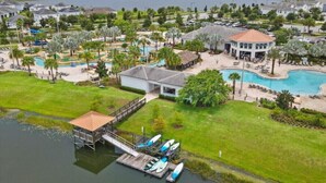 A resort with multiple swimming pools, a dock with boats, and a large body of water. - Last Minute Disney Getaway! Private Pool & Themed Bedrooms. Book Now! #65921 (Orlando)