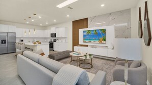 A modern living room with a sofa, coffee table, and TV.