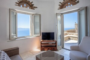 Enjoy a stunning sea view from the balcony, featuring a historic landmark in the distance.