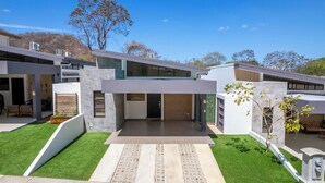 A modern two-story house with a flat roof, large windows, and a well-maintained lawn. - Sophisticated Home with a Chic Design and a Private Terrace with a Plunge Pool (Sardinal)