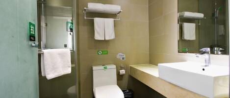 A bathroom with a toilet, sink, and towel rack.