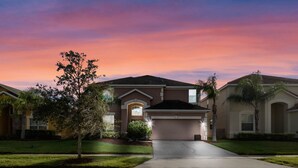A residential house with a driveway, garage, and a well-maintained lawn. - Last Minute Disney Getaway! Private Pool, Hot Tub & Game Room. Book Now! #65763 (Orlando)