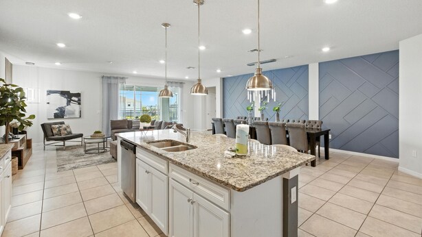 A spacious kitchen with granite countertops, a central island, and pendant lighting. - Last Minute Disney! Private Pool, Hot Tub, Game Room & Themed Bedrooms. Book Now! #128641 (Orlando)