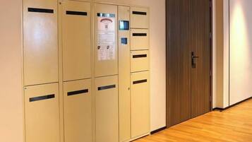 A row of beige lockers with a door to the right.