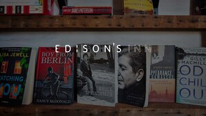 A bookshelf with various books, including titles like 'Boy from Berlin' and 'The Inconvenient Indian'. - Edisons Inn (Stratford)