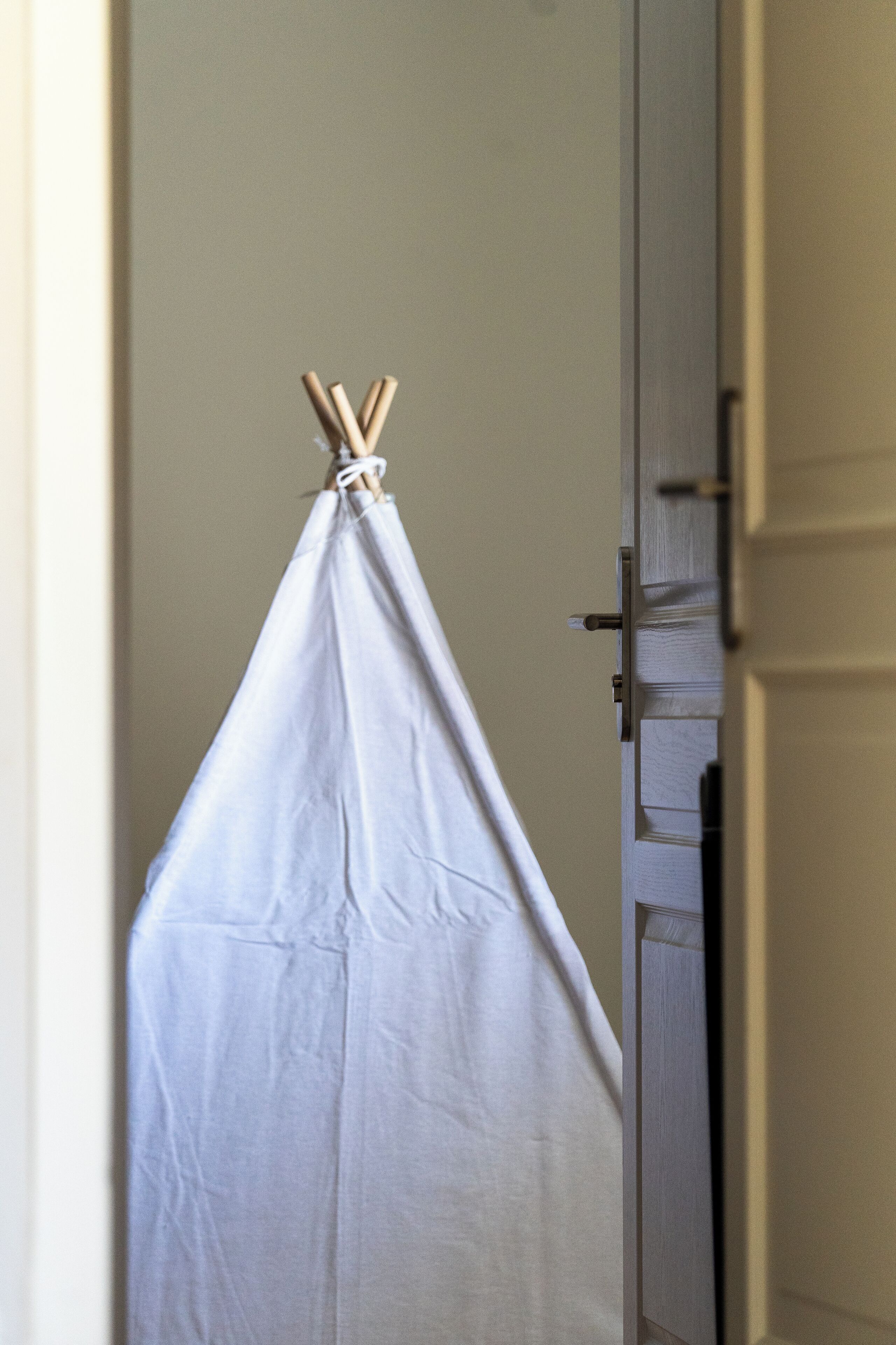 Una tela blanca colgada de una puerta, atada en la parte superior con un nudo.