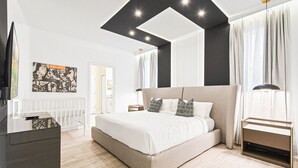 A modern bedroom with a large bed, a TV, and a ceiling light fixture. - Last Minute Disney! Private Pool, Hot Tub, Game Room & Themed Bedrooms. Book Now! #112977 (Orlando)