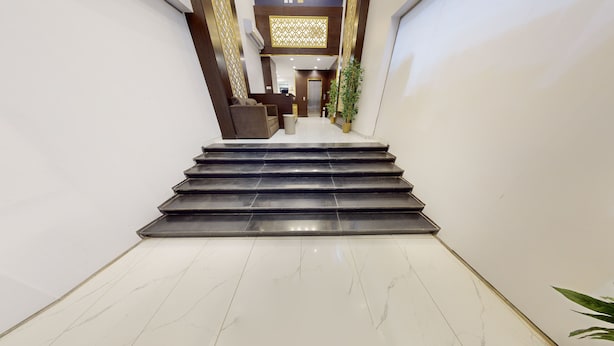 A staircase leading to an elevator in a modern building. - Hotel Al Madinah Hotel Apartments (Madinah)