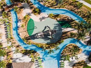 An aerial view of a resort with a central pool, surrounded by palm trees and lounge chairs. - Sophisticated 6BR at Storey Lake Sl2766 (Kissimmee)